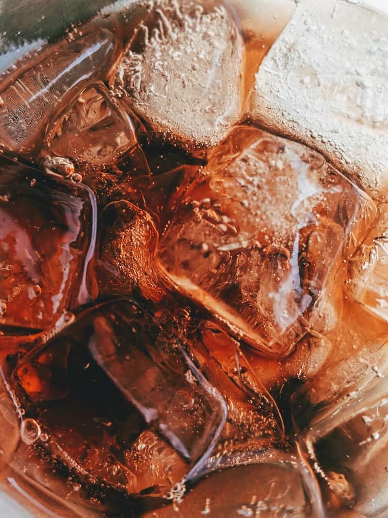 a close up photo of ice cubes in a drink, top-down